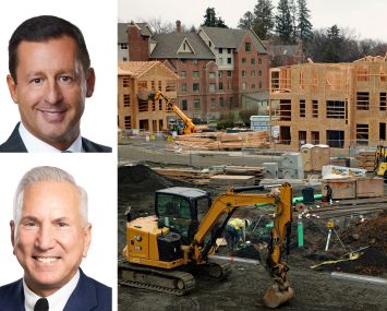 Todd Jones (left) and Stephen Rosenberg of Greystone, and apartment housing under construction.