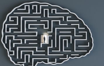 An illustration of a brain-shaped maze with a man standing in a doorway in the center.