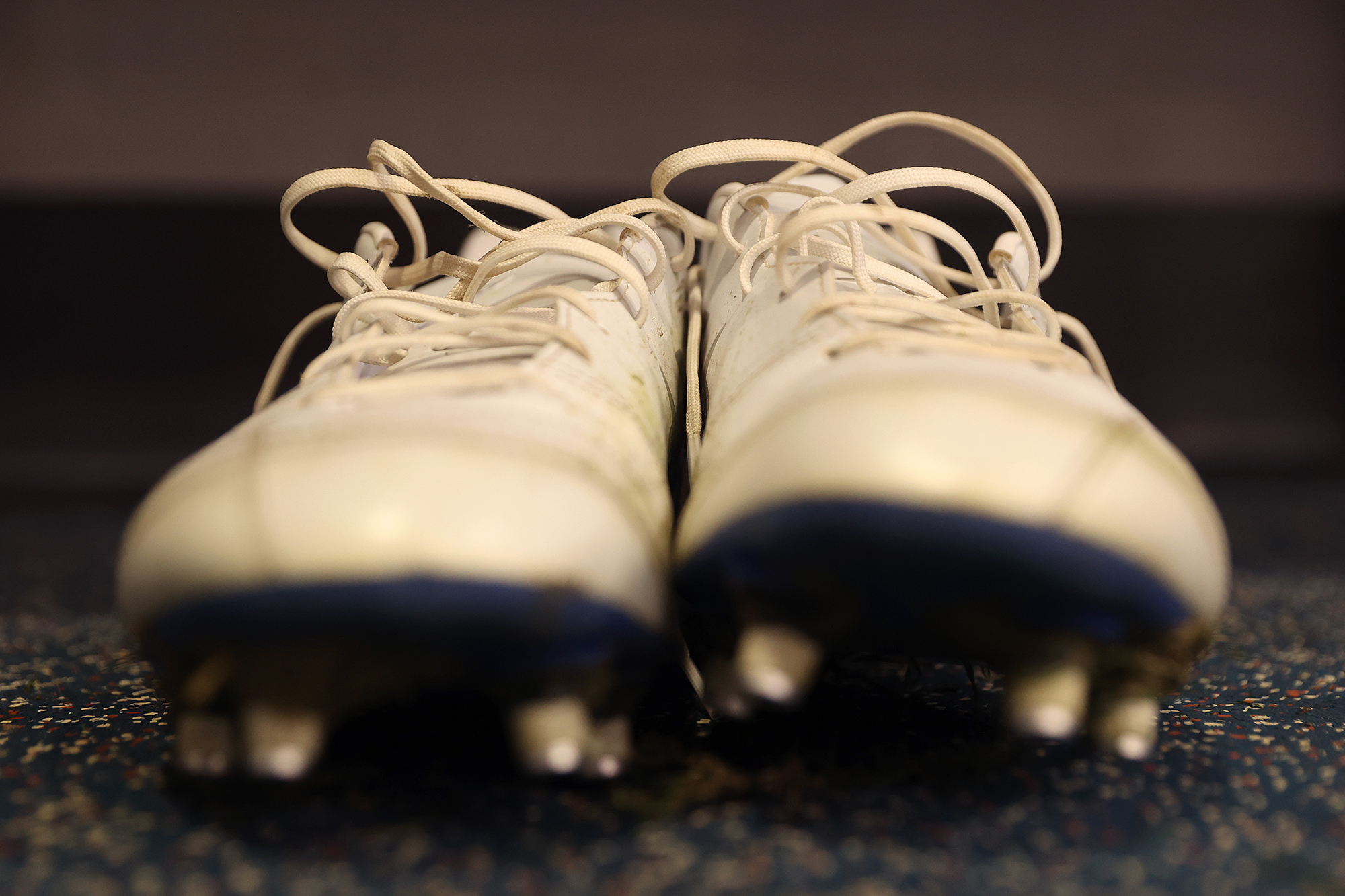 A detailed photo of a pair of white cleats.