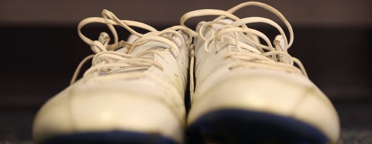 A detailed photo of a pair of white cleats.