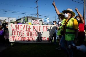 Protesters march towards Stevenson Middle School where a meeting is held about the status of recovery efforts from the 8-day fire at Lineage's cold-storage warehouse in Los Angeles.