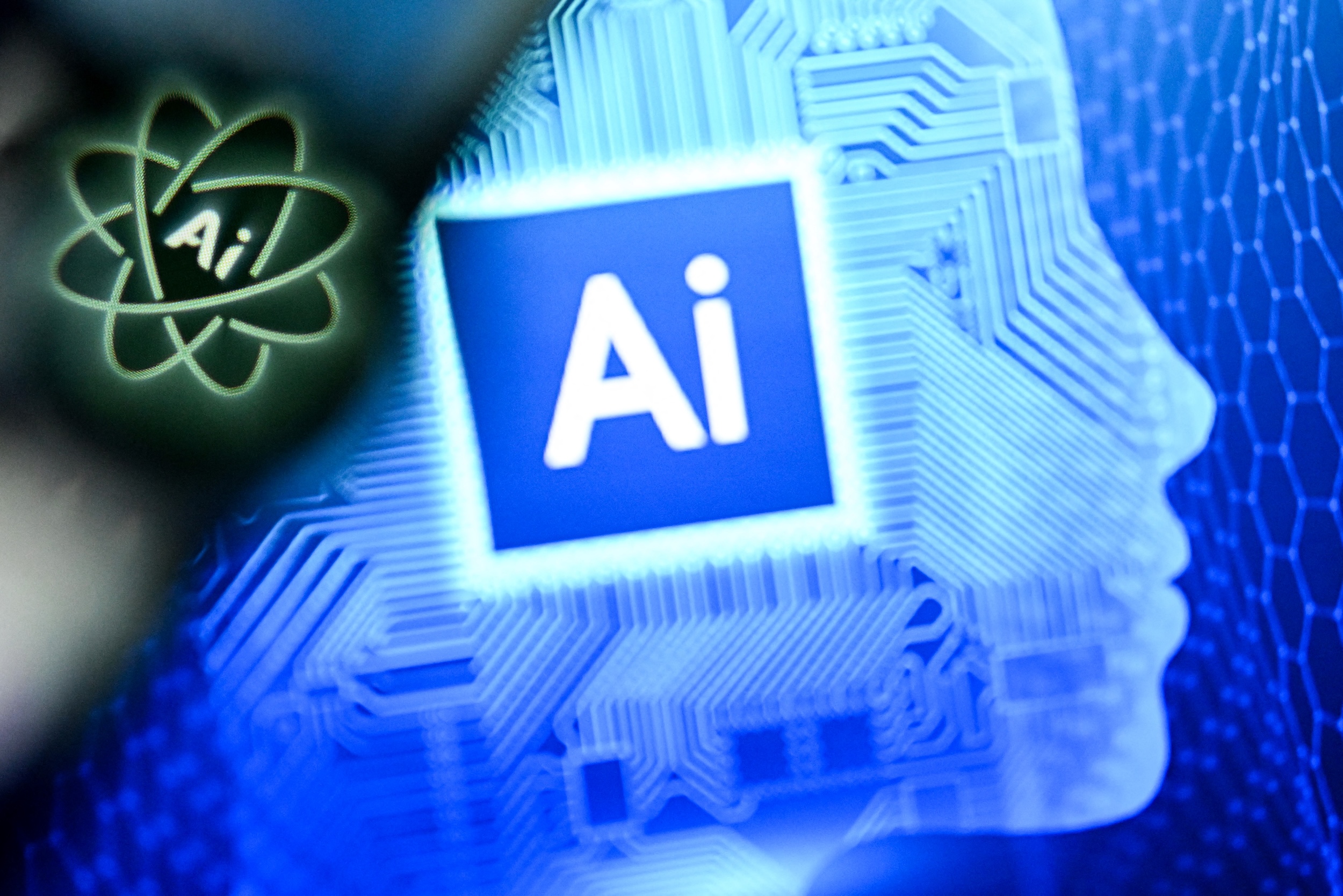 AI for Artificial Intelligence on a laptop screen (R) next to the logo of the Chat AI application on a smartphone screen.