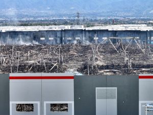 The distribution center for paper-goods manufacturer Kimberly-Clark smolders in Ontario, Calif., on April 14 after a fire destroyed the facility on April 7.