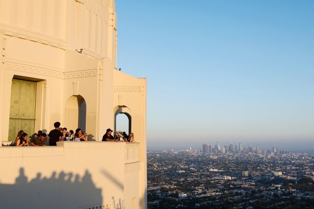 L.A. County Investment Sales Jump 28% in July Thanks to Multifamily People look at the Los Angeles skyline from Griffith Observatory.