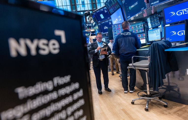 Traders work on the floor of the New York Stock Exchange.