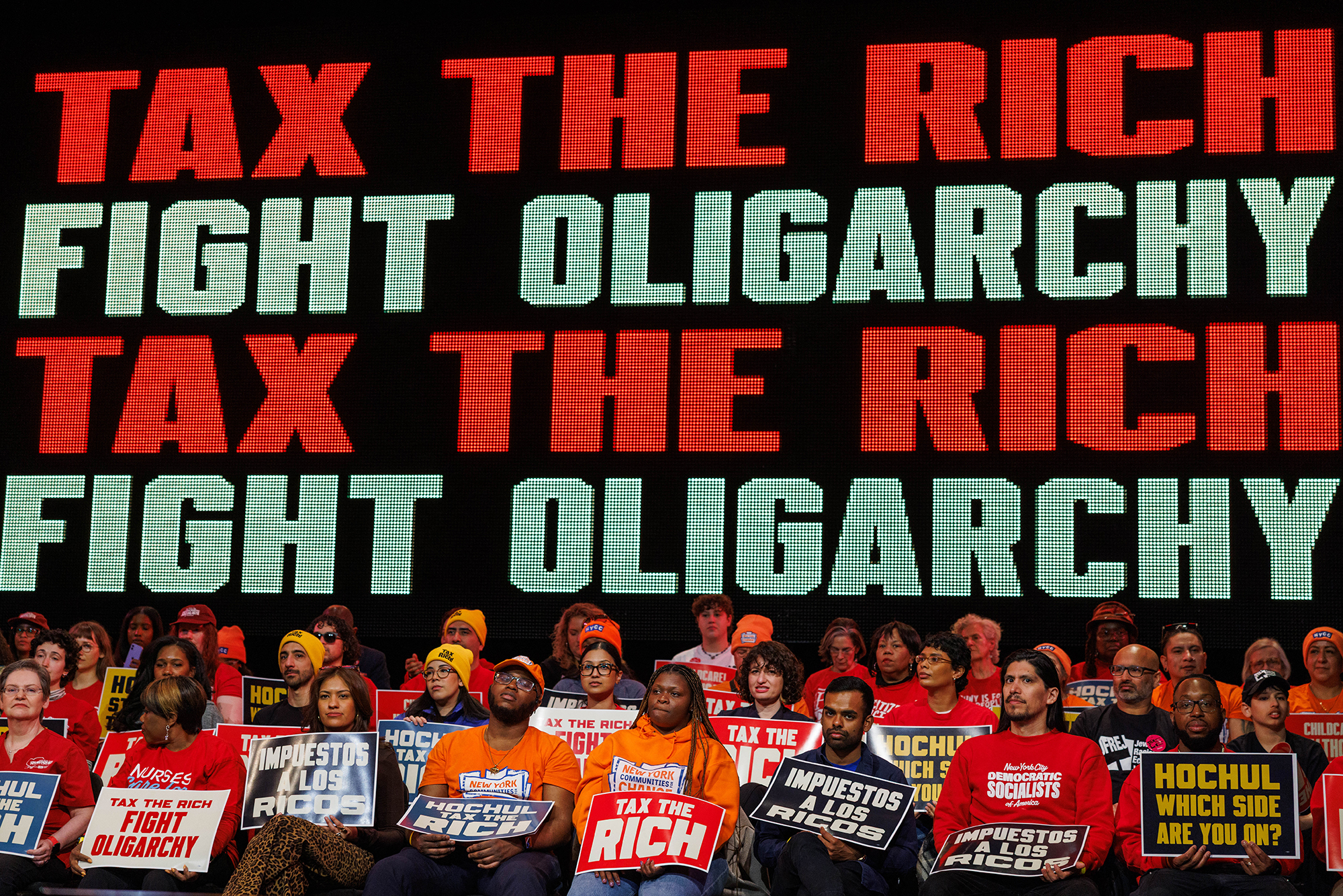 People attend a Tax The Rich rally hosted by the Democratic Socialists of America in the Bronx.