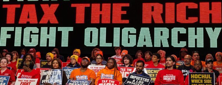 People attend a Tax The Rich rally hosted by the Democratic Socialists of America in the Bronx.