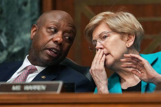 Sen. Tim Scott (R-SC) speaks to Sen. Elizabeth Warren (D-MA) during a Senate Committee on Banking, Housing, and Urban Affairs hearing.
