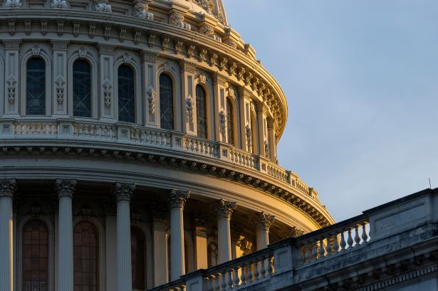 The sun sets behind the Capitol Building in Washington, D.C.