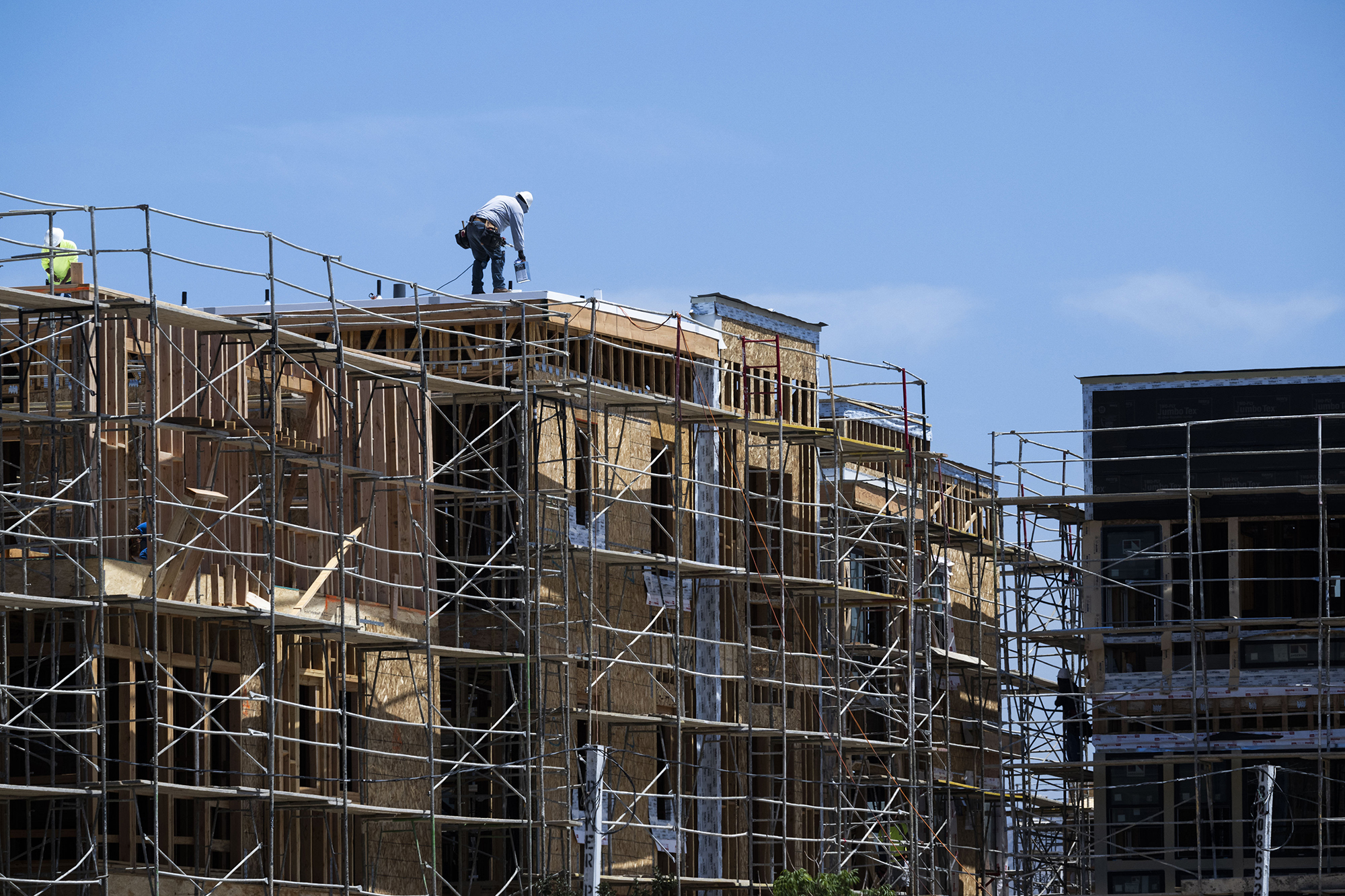 A contractor works on the construction of a house.