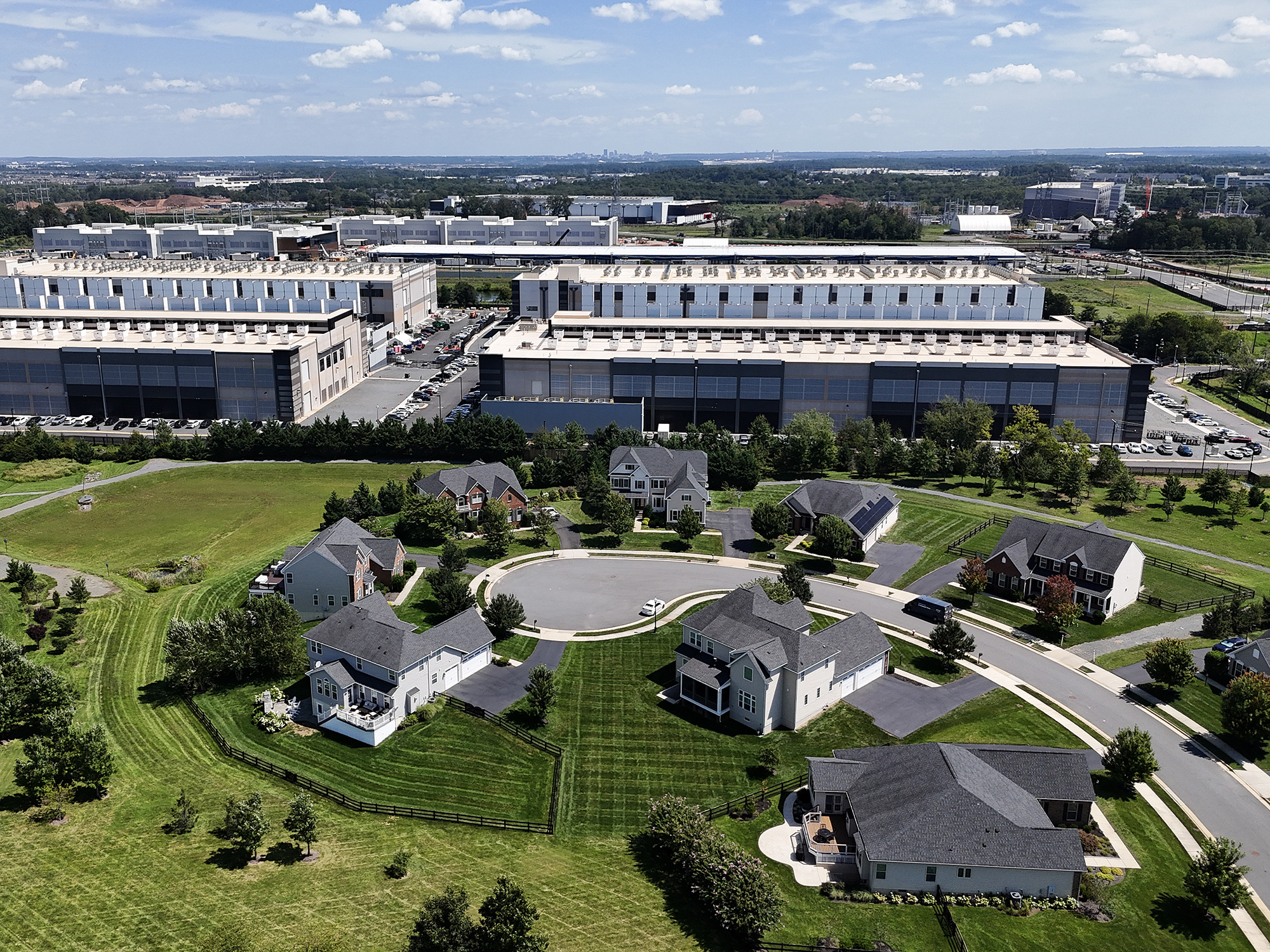 An Amazon Web Services data center stands near homes in Stone Ridge, Va., in August 2026.