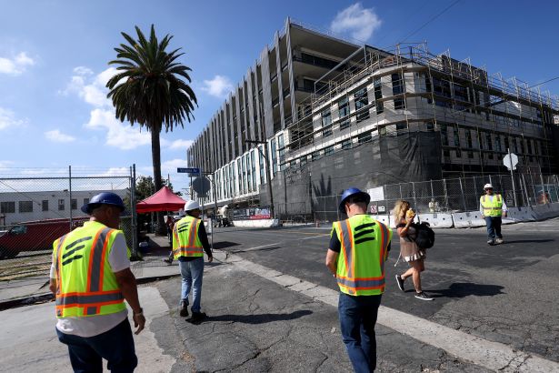 Developer and landlord David Simon, second from left, and others walk towards Echelon Studios, a new movie studio being built in Hollywood on September 4, 2026.