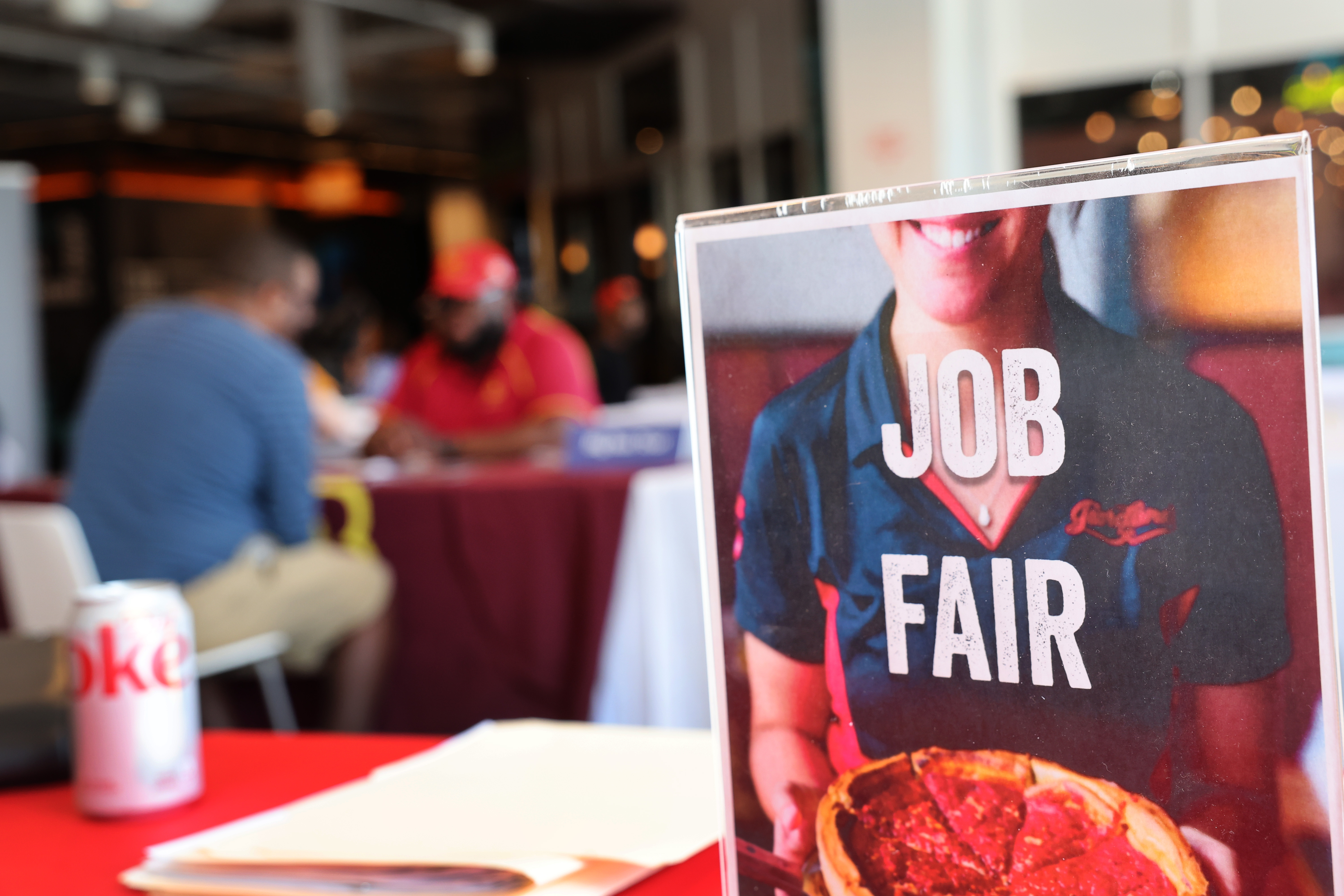 Job seekers speak with recruiters during a job fair in Chicago, Ill.