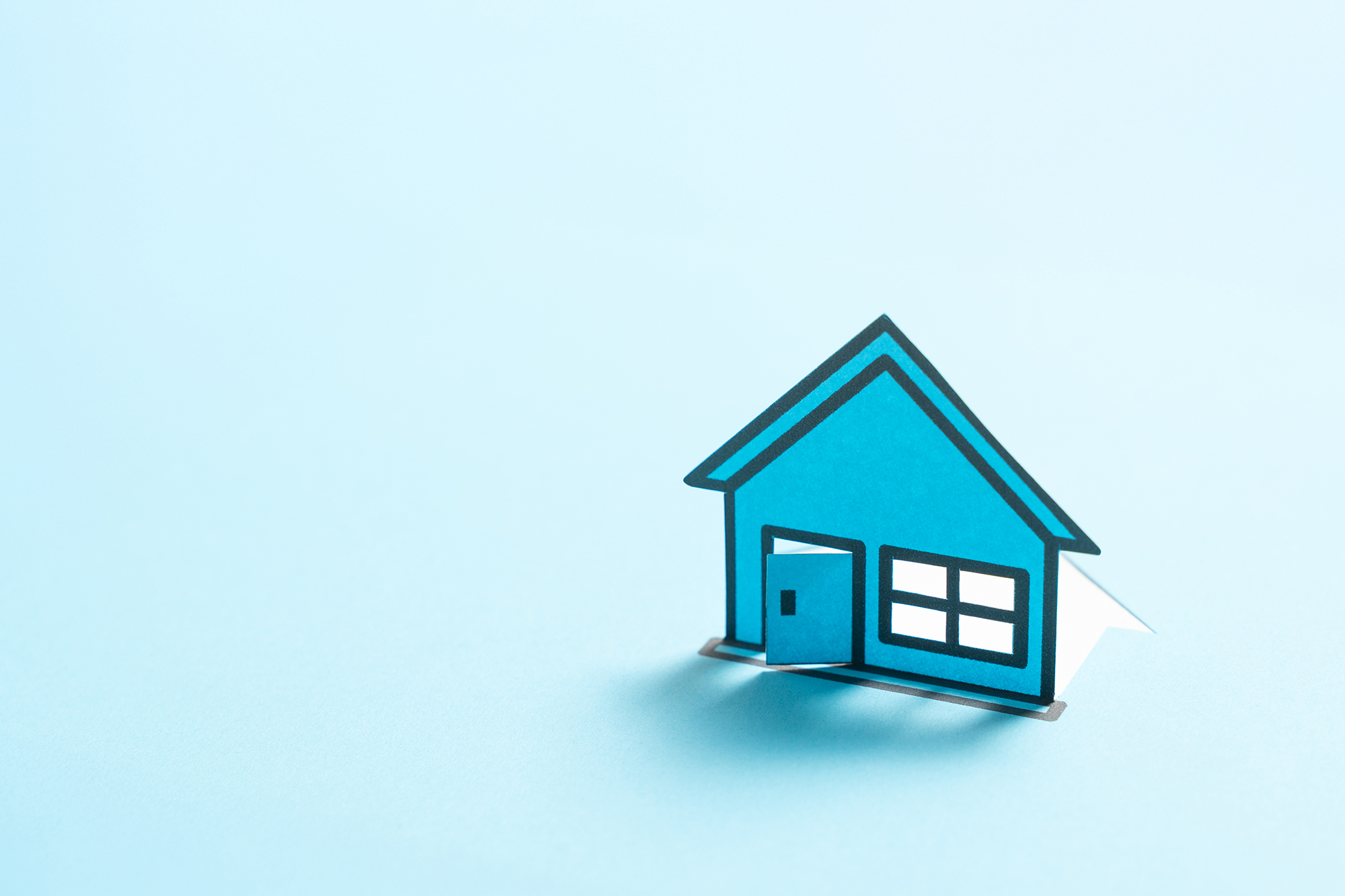 Illo of a blue paper model home against a vibrant blue background.