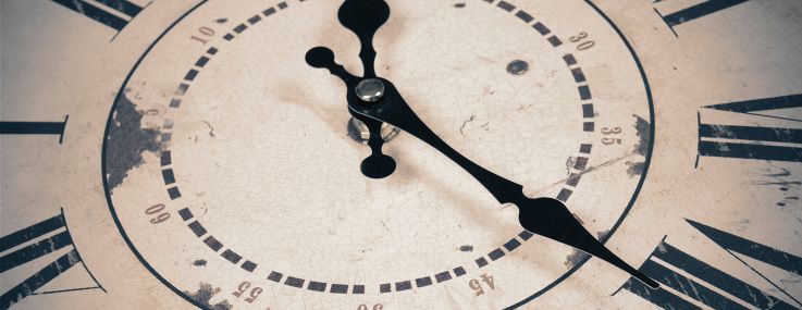 A close up of a vintage clock.