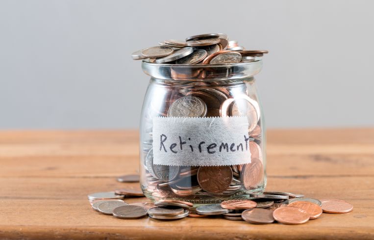 A jar filled with coins labeled "retirement."