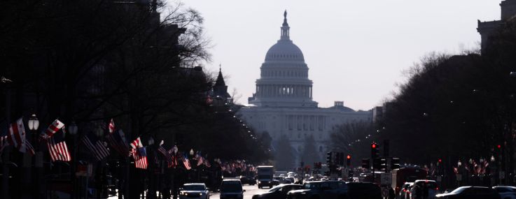 Commuters cross Pennsylvania Avenue in downtown Washington, DC.