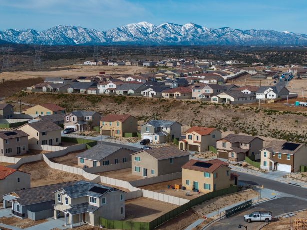 In an aerial view, snow on the San Gabriel Mountains is visible in the distance as houses are constructed at the massive 9,000-acre master-planned Silverwood community project in the Summit Valley area of Hesperia, California. The project could have as much as a multi-billion-dollar economic impact on the area. More than 15,000 homes are slated for construction.