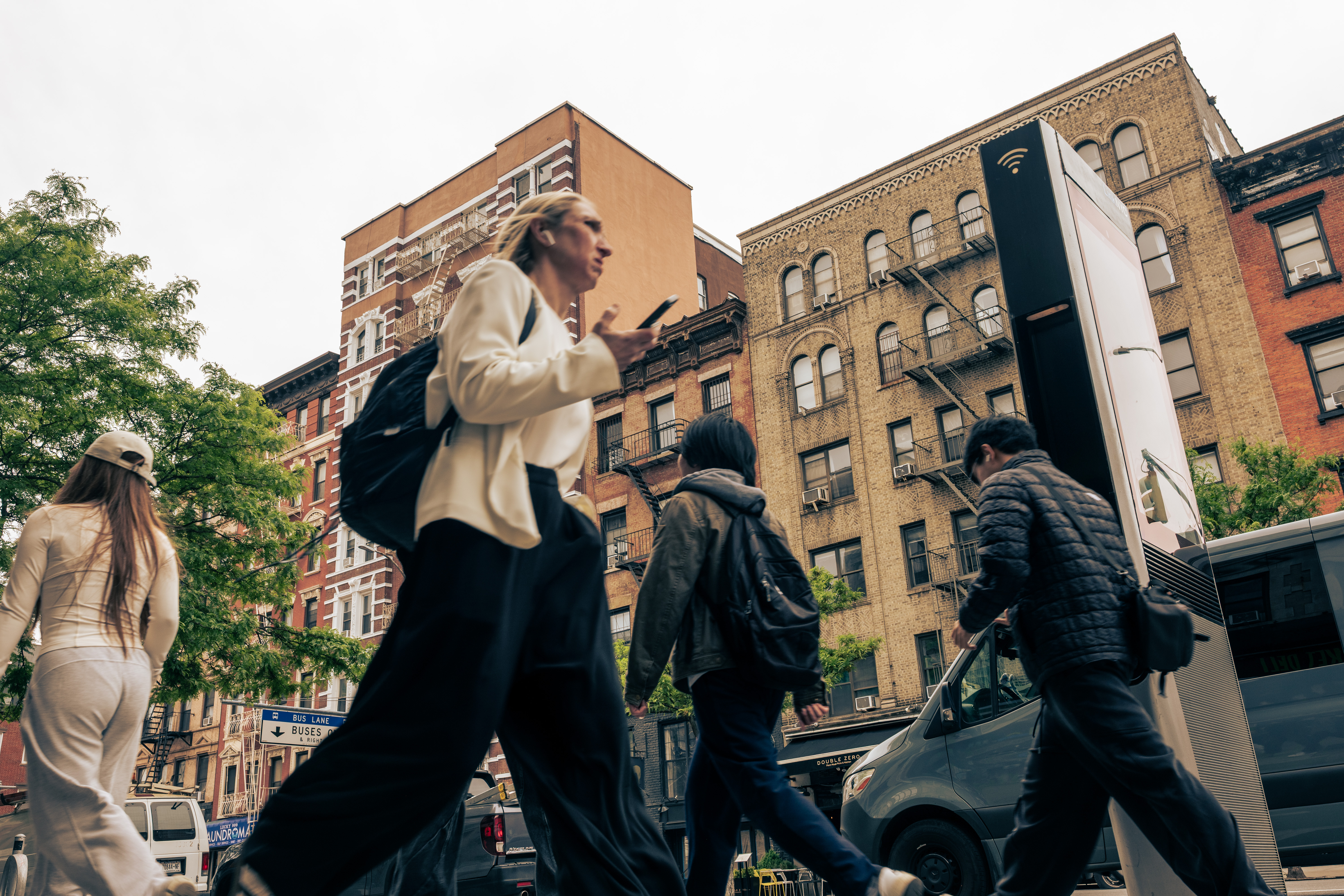 People walk past apartment buildings in the East Village.