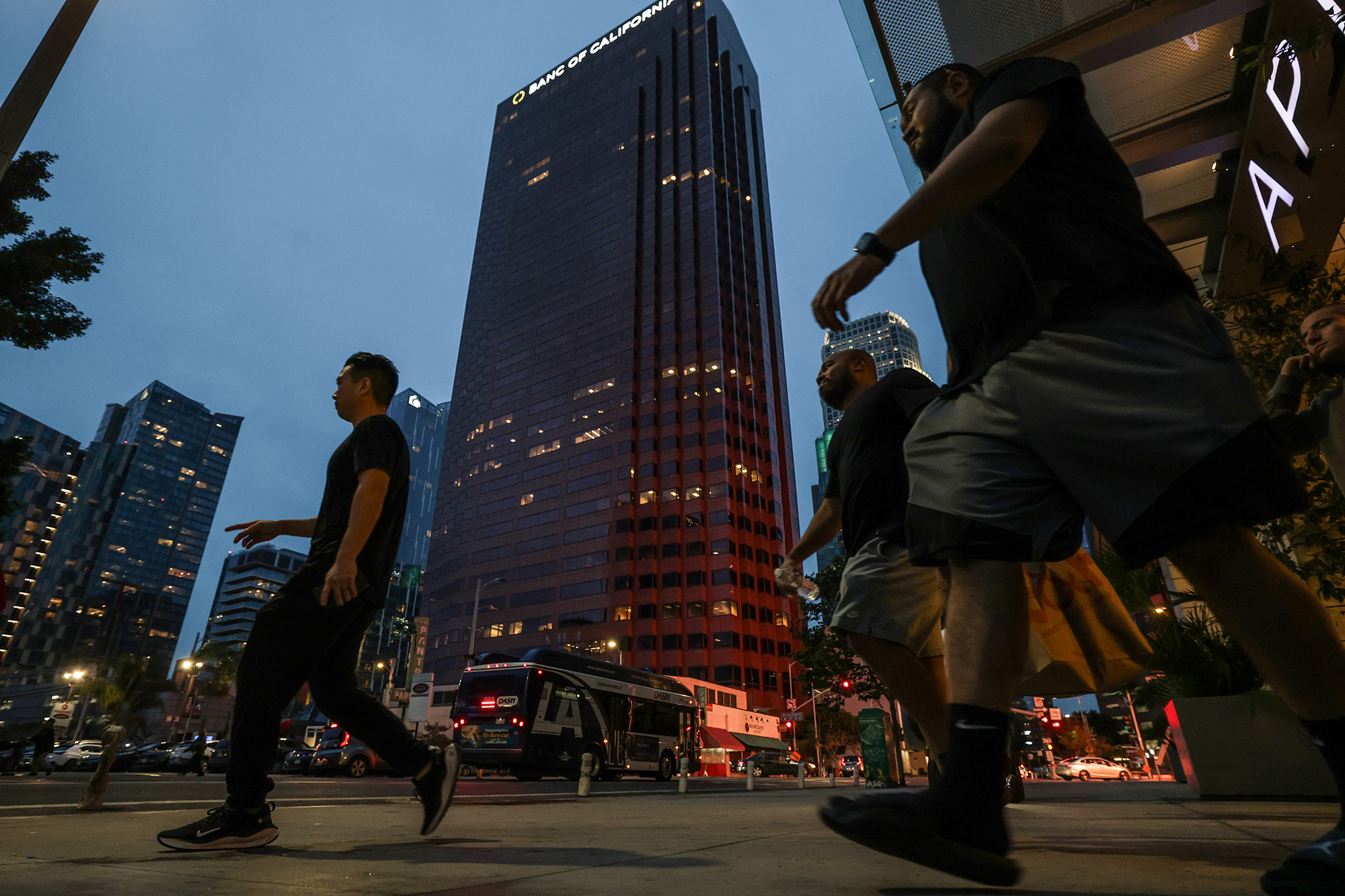 Pedestrians pass by buildings in downtown in Los Angeles.