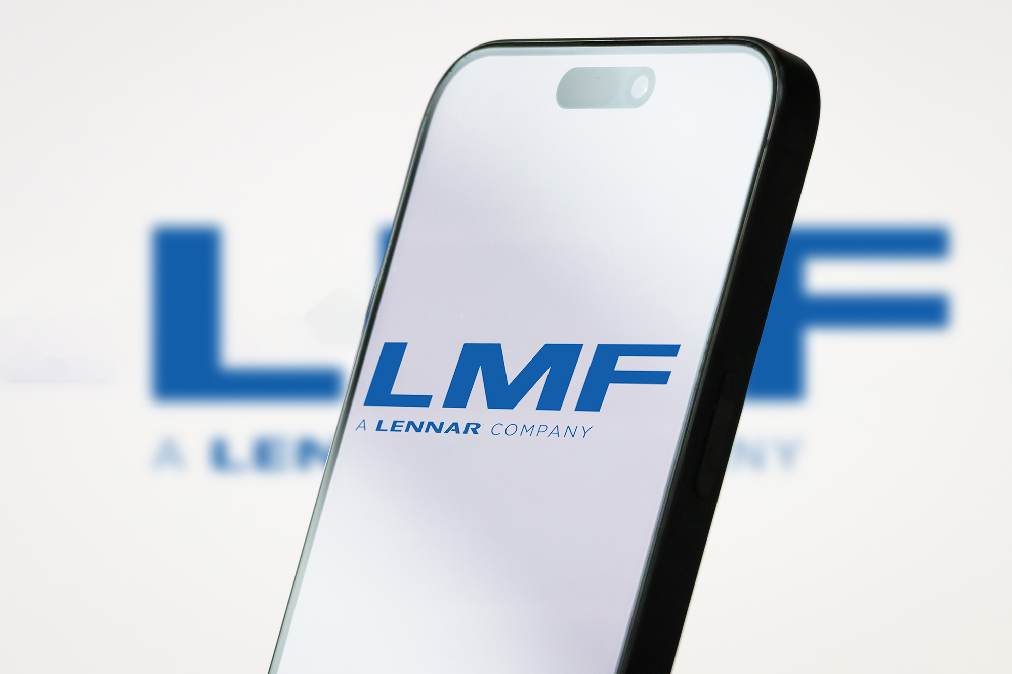 LMF Commercial's logo on a mobile phone screen.