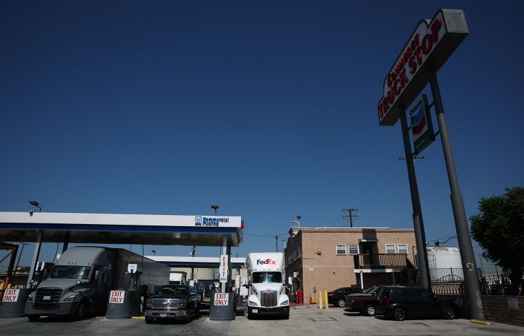 A driver parks a FedEx Freight truck near a diesel fuel pump station at a truck stop in Commerce, Calif.