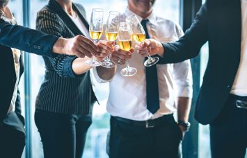 Group of business people toasting champagne glasses for a celebration.