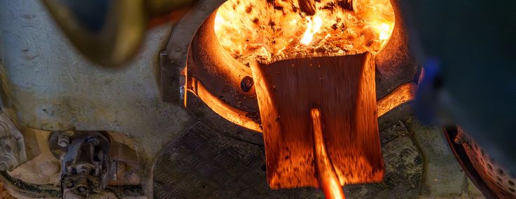 Coal being shoveled into the firebox of an old steam ship.