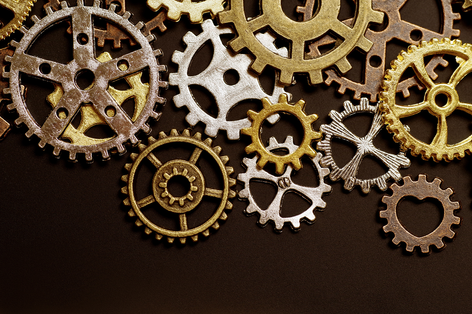 Various machinery gears lying in a pile.